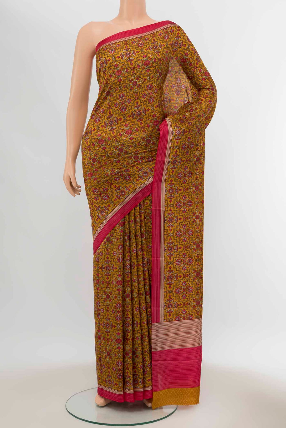 Mustard Printed Silk Saree with Floral Print on the body and Silk Border displayed on a mannequin