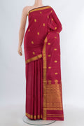 Maroon Kanjivaram Silk Saree with Zari Butta on the body and Zari Border.  displayed on a mannequin