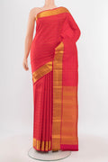 Peach Kanchipuram Silk Saree with Zari Butta on the body and Silk Border.  displayed on a mannequin
