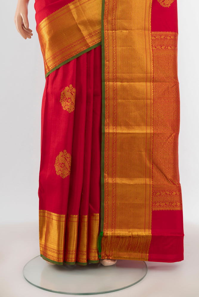 Pleats and pallu of Red Kanjivaram Silk Saree with Zari Butta on the body and Zari Border. 