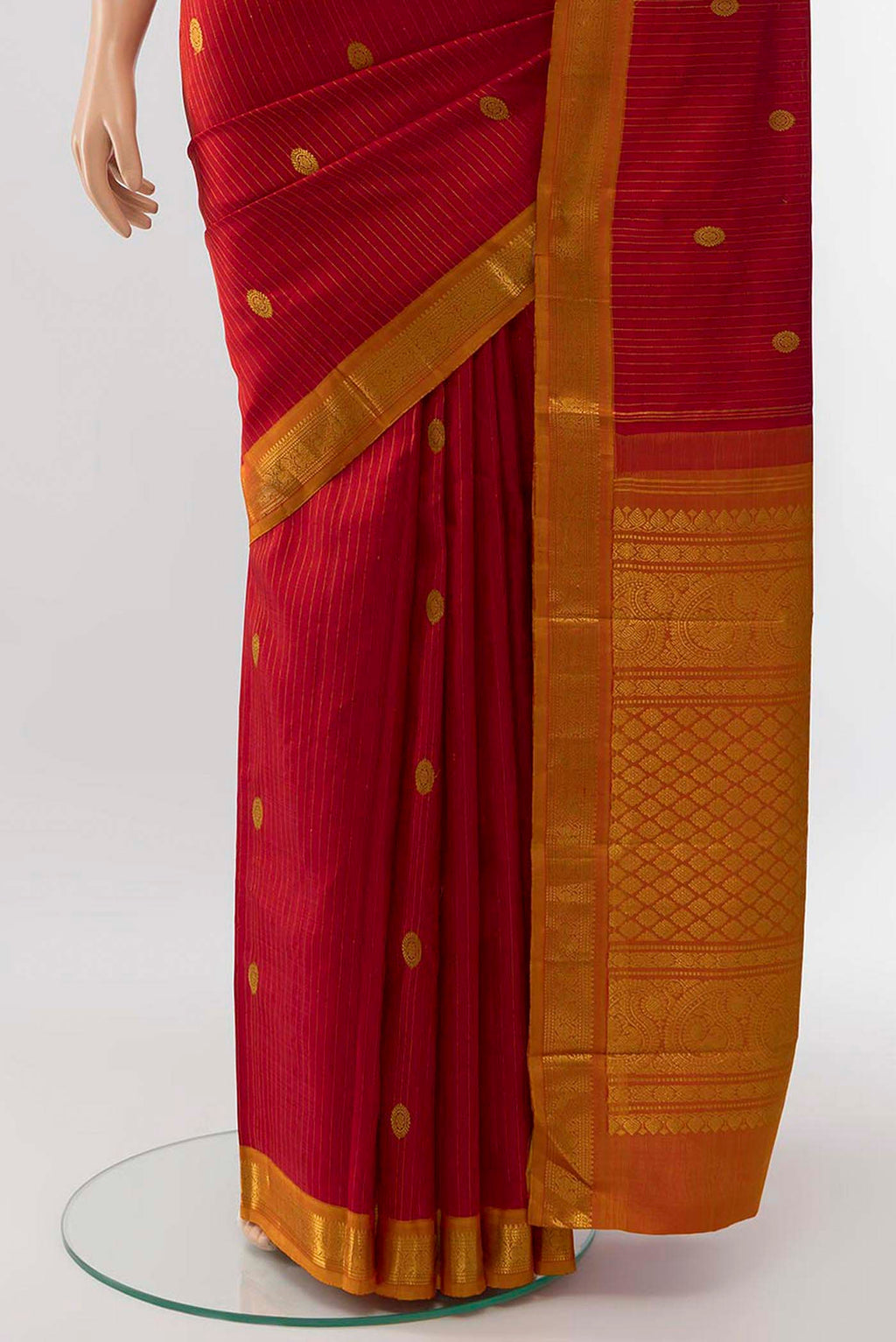 Pleats and pallu of Red Kanchipuram Silk Saree with Zari Butta on the body and Silk Border