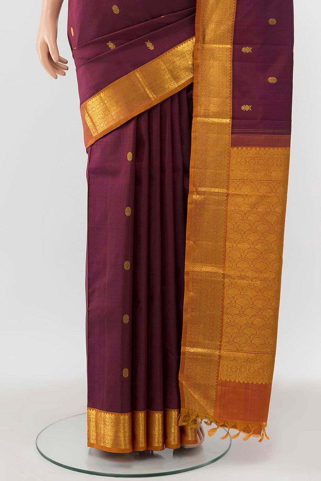 Pleats and pallu of Maroon Kanchipuram Silk Saree with Zari Butta on the body and Silk Border