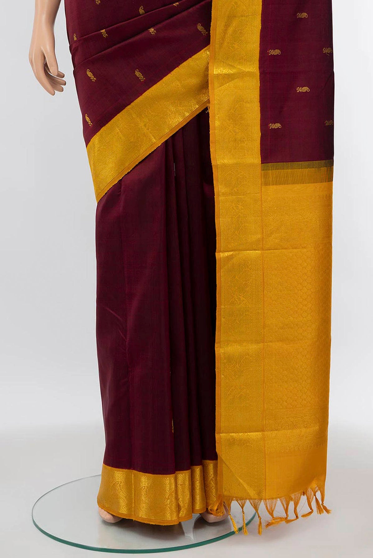 Pleats and pallu of Maroon Kanchipuram Silk Saree with Plain Body and Zari Border