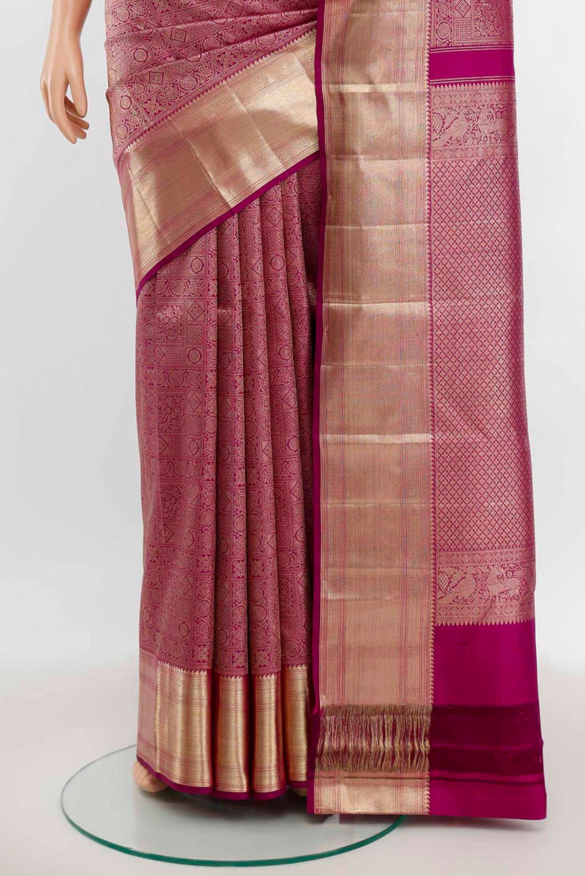 Pleats and pallu of Purple Kanchipuram Silk Saree with Zari Butta on the body and Silk Border. 