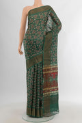Green Tussar Silk Saree with Floral Print on the body and Zari Border.  displayed on a mannequin