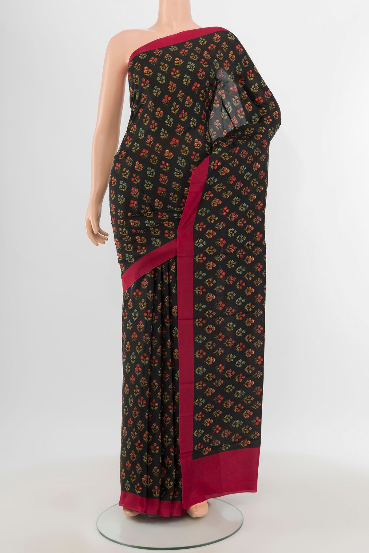 Black Printed Silk Saree with Floral Print on the body and Printed Border.  displayed on a mannequin