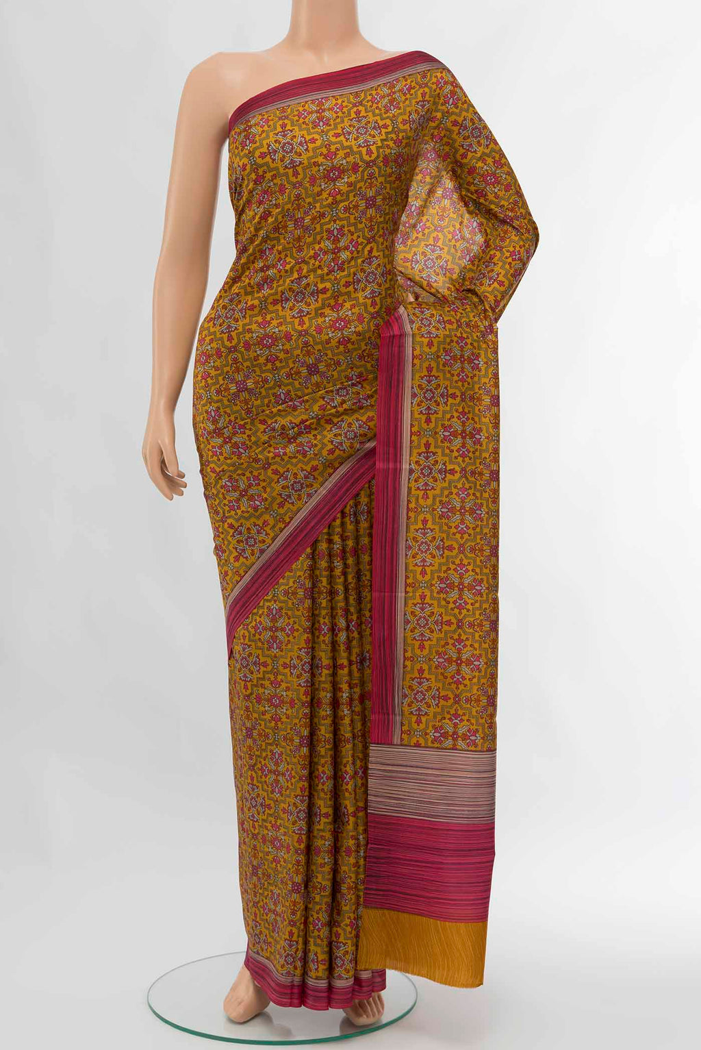 Rust Printed Silk Saree with Floral Print on the body and Silk Border displayed on a mannequin