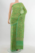 Green Printed Silk Saree with Printed design on the body and Printed Border.  displayed on a mannequin