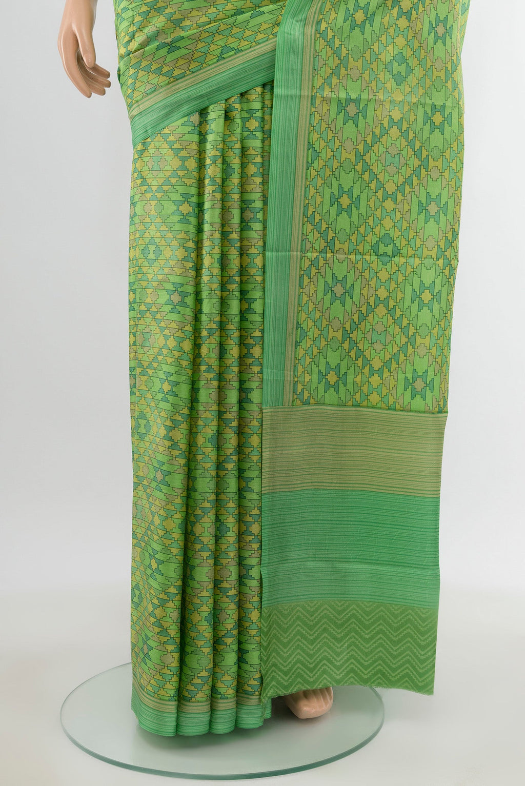 Pleats and pallu of Green Printed Silk Saree with Printed design on the body and Printed Border. 
