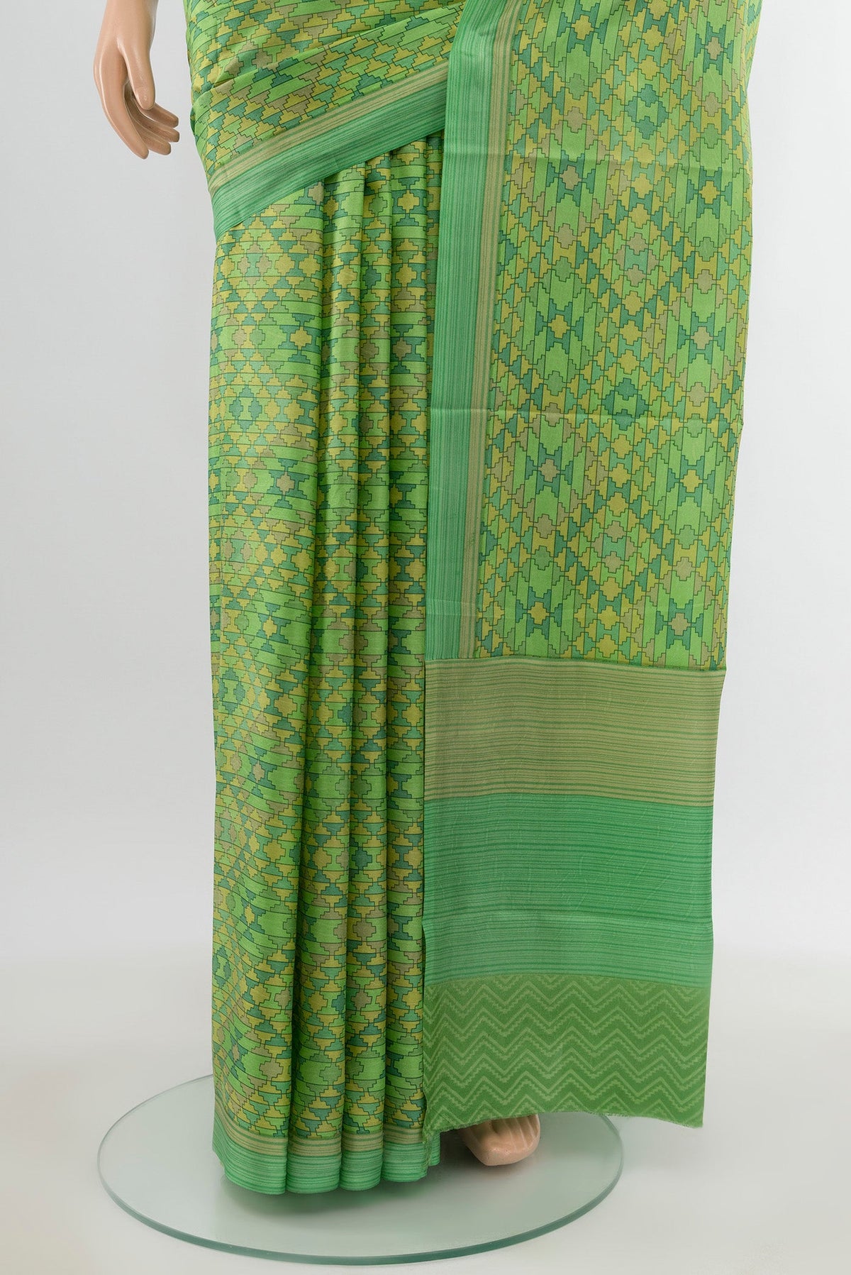 Pleats and pallu of Green Printed Silk Saree with Printed design on the body and Printed Border. 