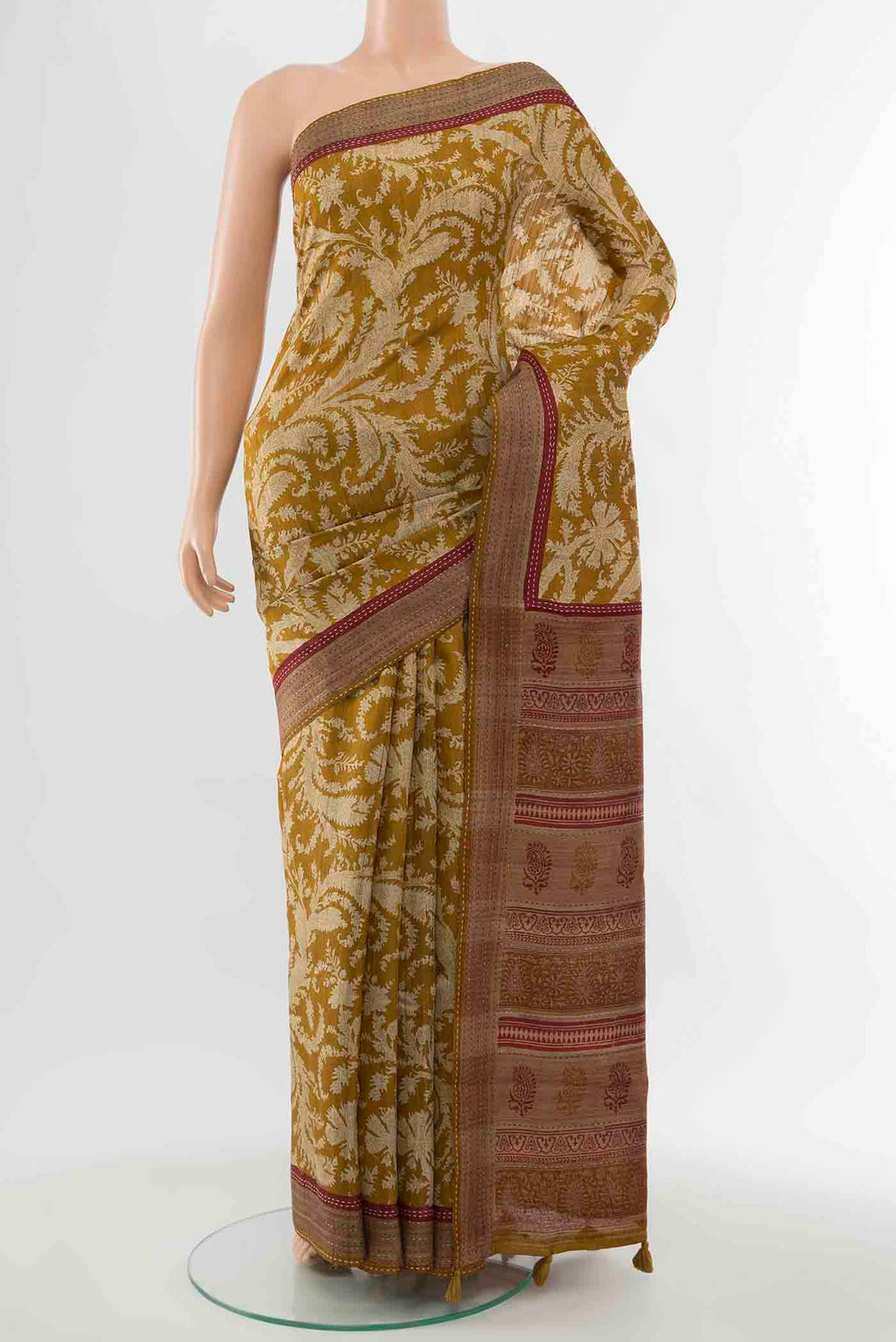 Mustard Tussar Silk Saree with Printed design on the body and Embroidery Border displayed on a mannequin