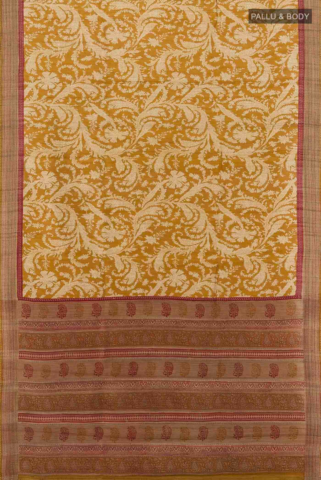 Flat view of Mustard Tussar Silk Saree with Printed design on the body and Embroidery Border