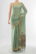 Pista Green Art Silk Saree with Zari Butta on the body and Silk Border displayed on a mannequin