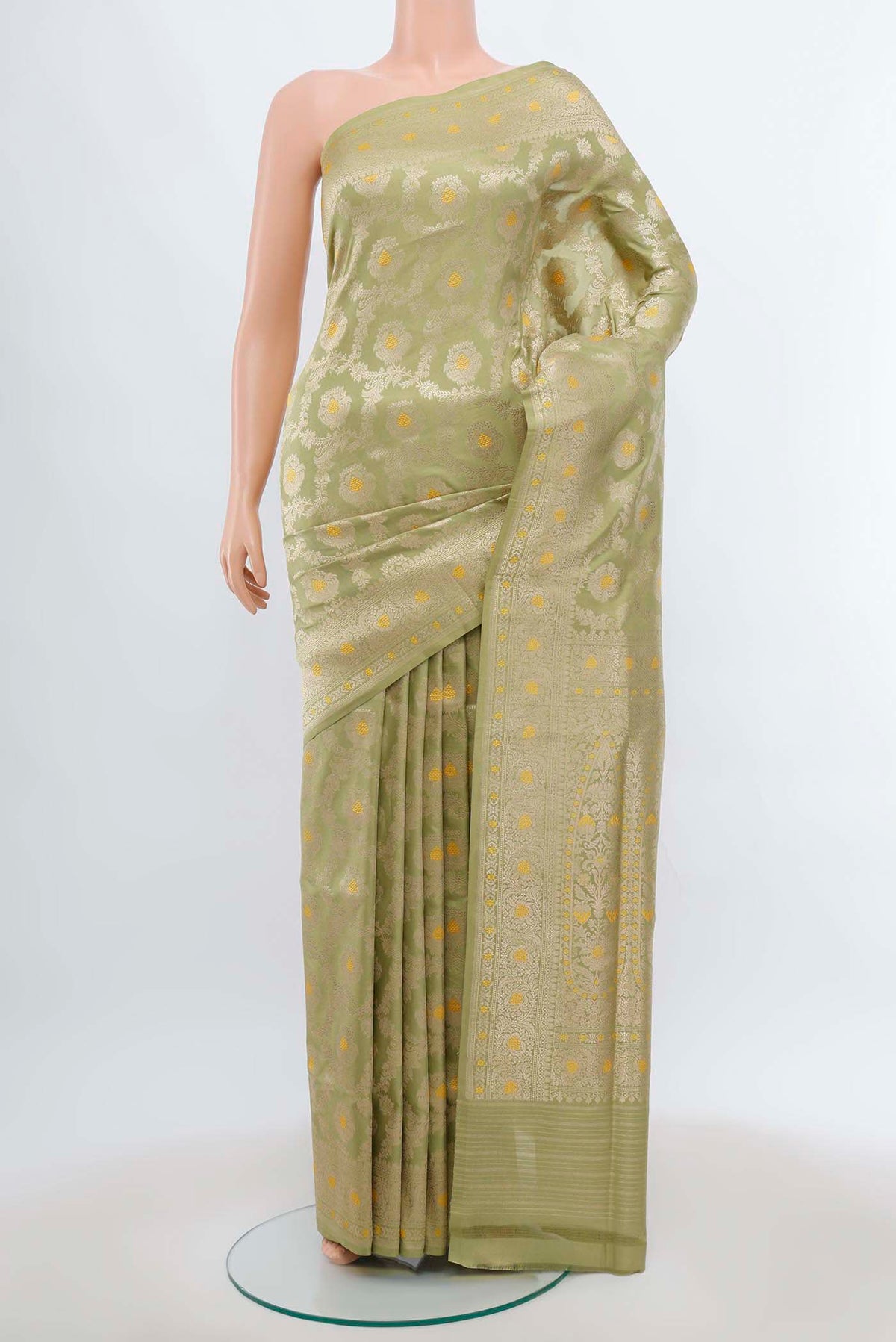 Pista Green Banarasi Silk Saree with Zari Brocade on the body and Silk Border.  displayed on a mannequin