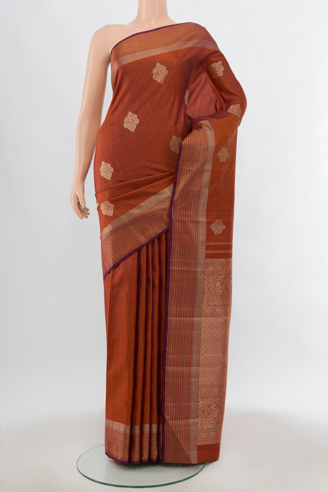 Bronze Kanjivaram Silk Saree with Zari Butta on the body and Silk Border.  displayed on a mannequin