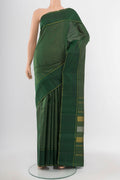 Bottle Green Kanchipuram Silk Saree with Zari Butta on the body and Silk Border.  displayed on a mannequin
