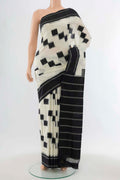 Cream Pochampally Cotton Saree with Ikat Print on the body and Fancy Border displayed on a mannequin
