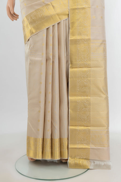 Pleats and pallu of Beige Kanchipuram Silk Saree with Zari Butta on the body and Zari Border. 