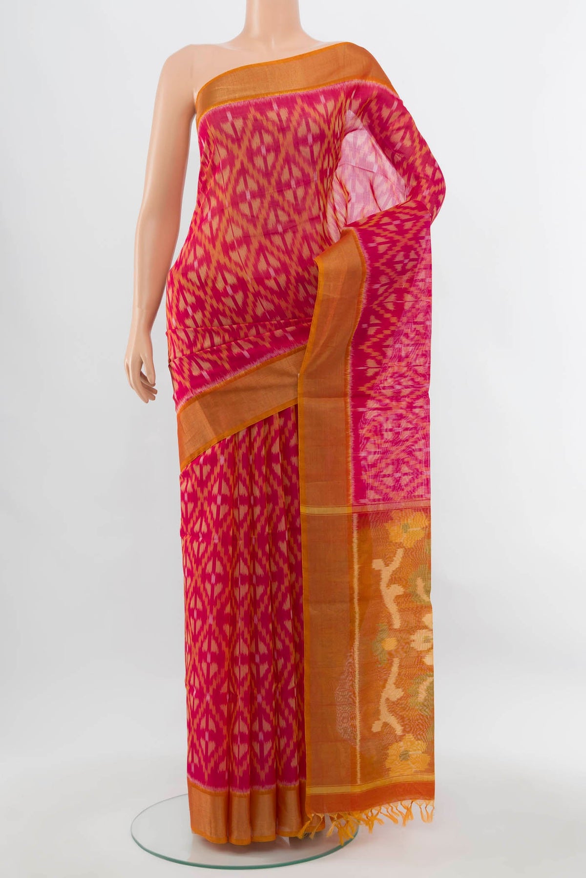 Magenta Maheshwari Silk Cotton Saree with Ikat Print on the body and Silk Border.  displayed on a mannequin