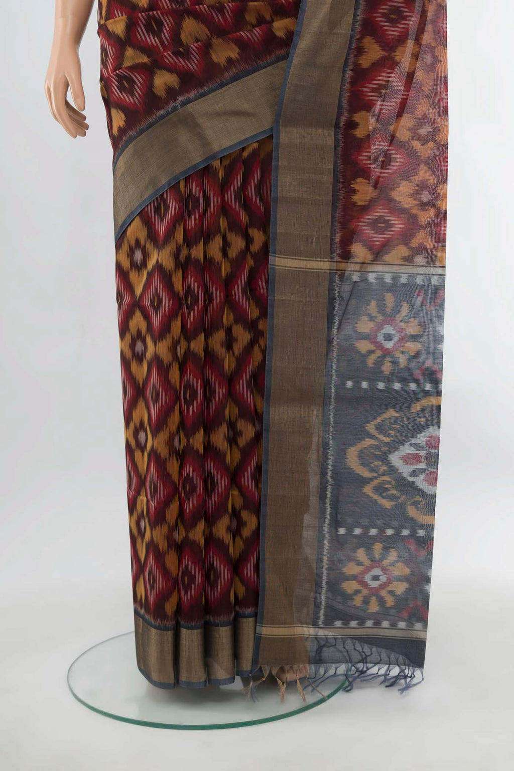 Pleats and pallu of Maroon Maheshwari Silk Cotton Saree with Ikat Print on the body and Silk Border. 