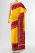 Yellow Rajkot Patola Silk Saree with Ikat Print on the body and Silk Border.  displayed on a mannequin