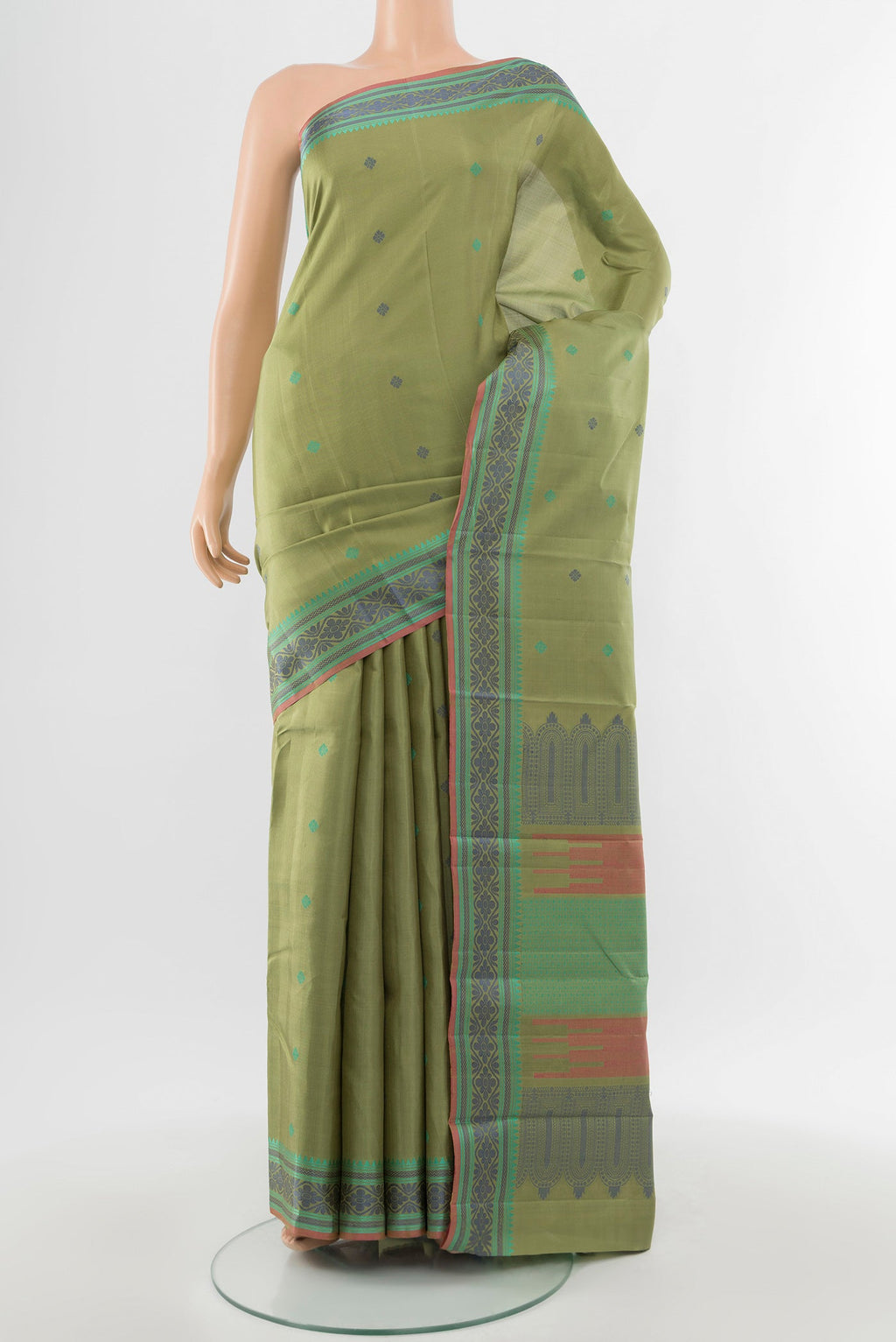 Pure Silk Pure Zari Light Green Kanchipuram Saree with Zari Butta on the body and Silk Border.  displayed on a mannequin