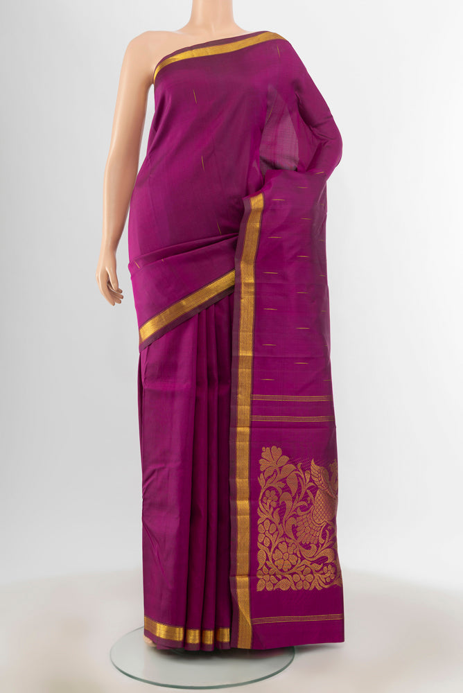 Purple Kanjivaram Silk Saree with Zari Butta on the body and Zari Border.  displayed on a mannequin