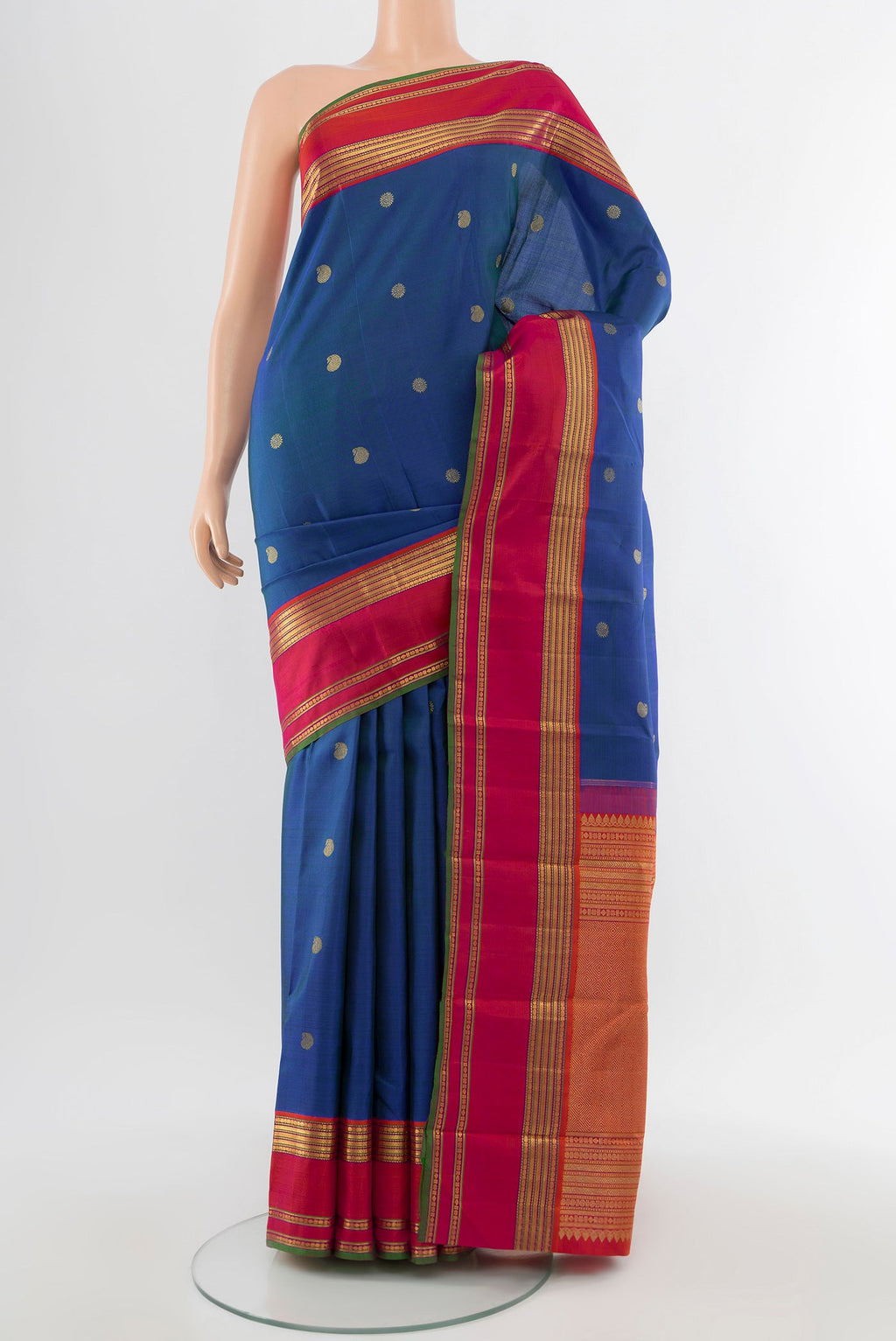 Pure Silk Pure Zari Peacock Blue Kanchipuram Saree with Zari Butta on the body and Silk Border.  displayed on a mannequin