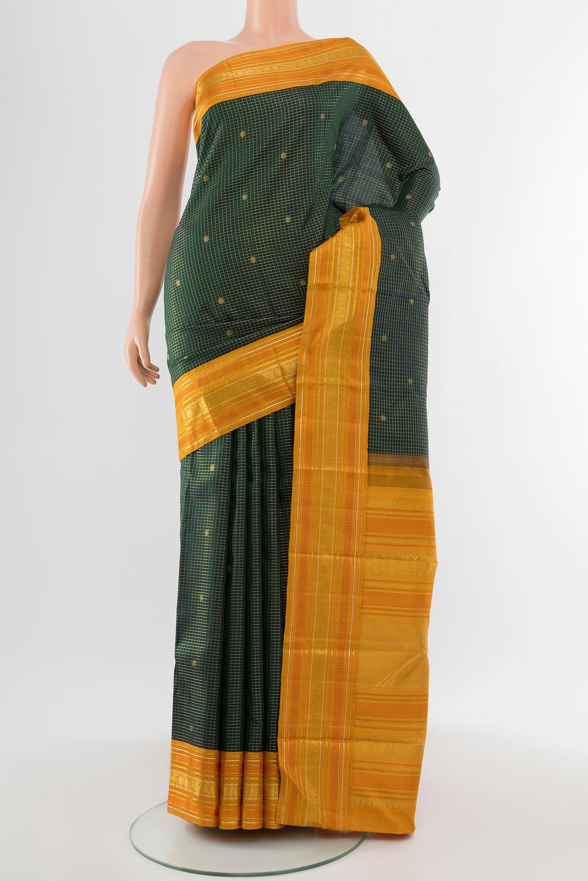 Pure Silk Pure Zari Bottle Green Kanjivaram Saree with Zari Butta on the body and Silk Border.  displayed on a mannequin