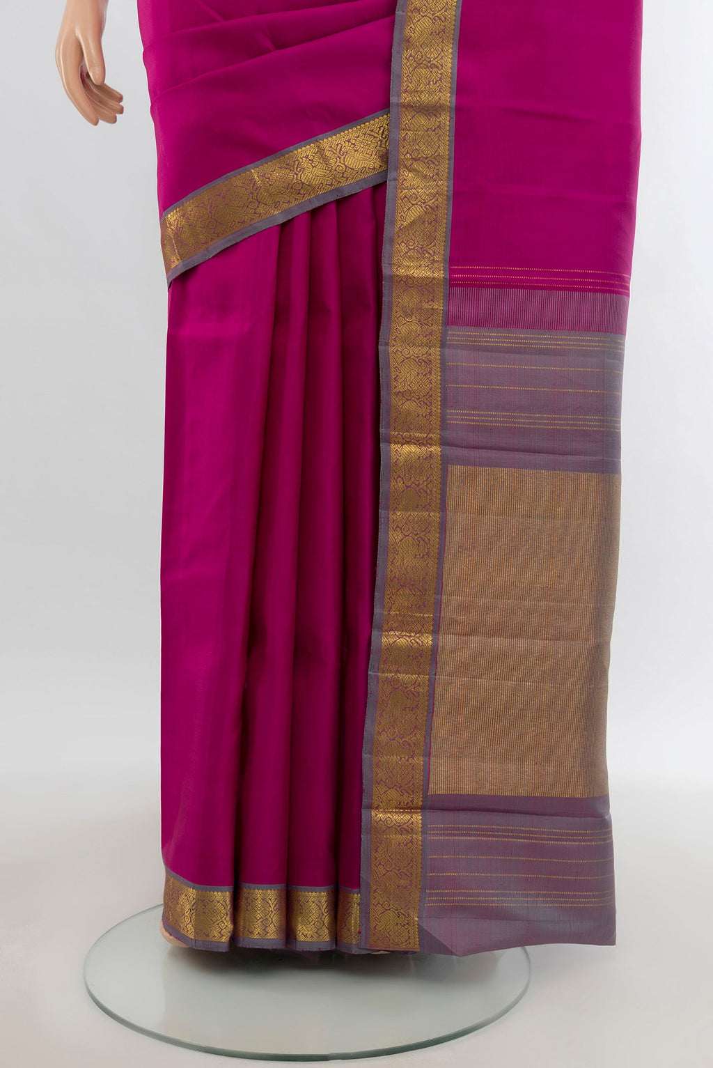 Pleats and pallu of Rani Pink Kanchipuram Silk Saree with Zari Butta on the body and Zari Border. 