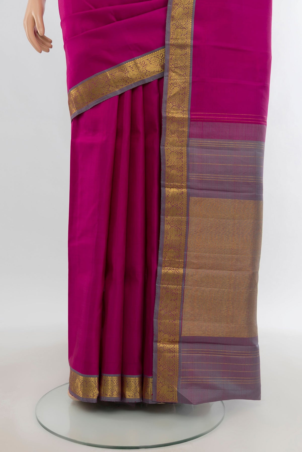 Pleats and pallu of Rani Pink Kanchipuram Silk Saree with Zari Butta on the body and Zari Border. 