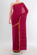 Maroon Kanchipuram Silk Saree with Plain Body and Zari Border.  displayed on a mannequin