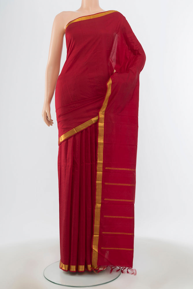 Maroon Kanchipuram Silk Saree with Plain Body and Zari Border.  displayed on a mannequin