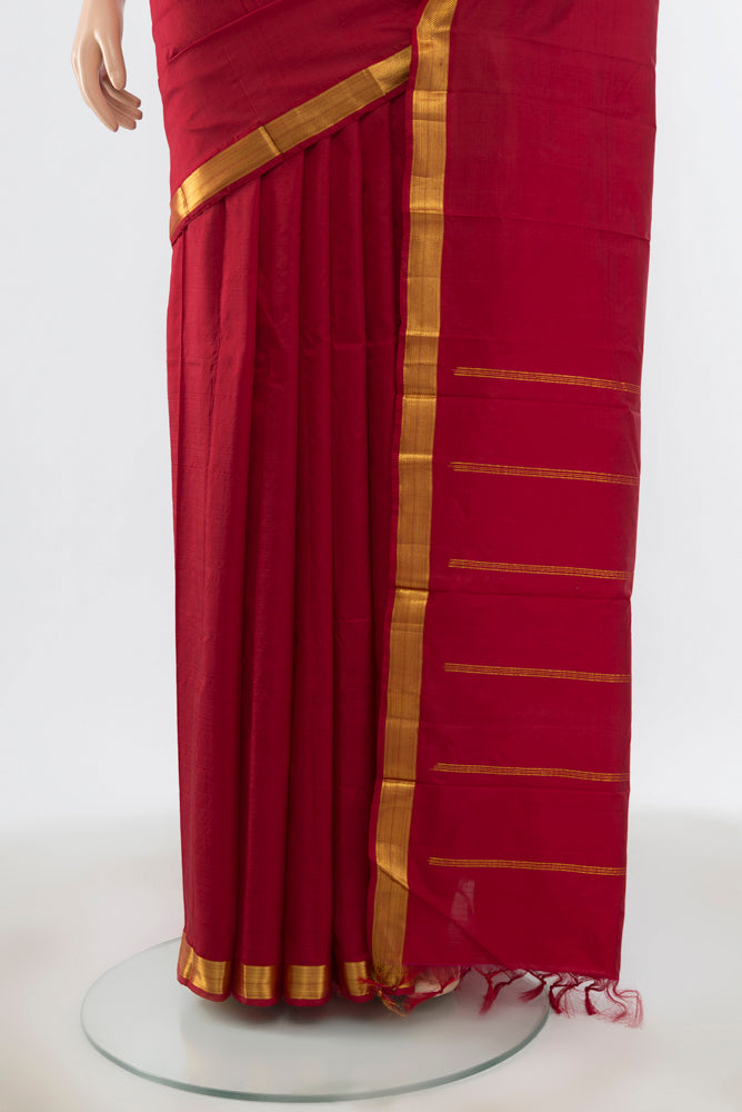 Pleats and pallu of Maroon Kanchipuram Silk Saree with Plain Body and Zari Border. 