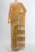 Mustard Tussar Silk Saree with kalamkari Print on the body and Zari Border.  displayed on a mannequin