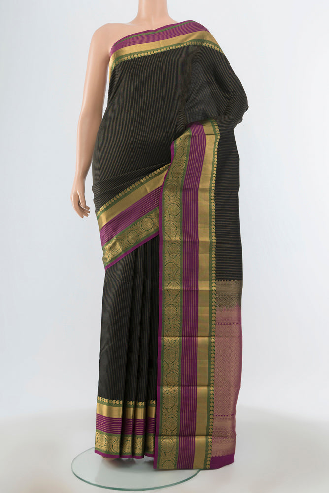 Black Kanjivaram Silk Saree with Zari Butta on the body and Zari Border.  displayed on a mannequin