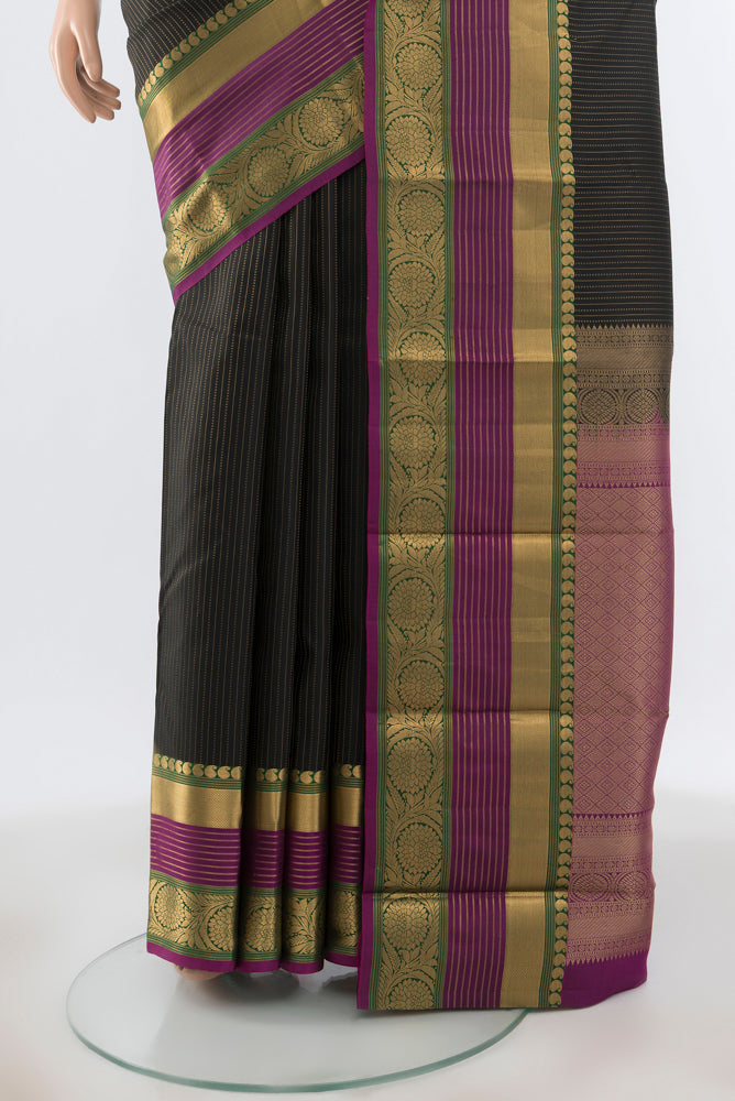 Pleats and pallu of Black Kanjivaram Silk Saree with Zari Butta on the body and Zari Border. 