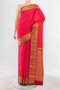 Peach Kanchipuram Silk Saree with Zari Brocade on the body and Silk Border.  displayed on a mannequin