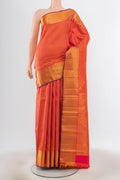 Peach Kanjivaram Silk Saree with Zari Butta on the body and Silk Border.  displayed on a mannequin