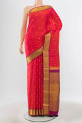 Pure Silk Pure Zari Peach Kanjivaram Saree with Zari Butta on the body and Silk Border.  displayed on a mannequin