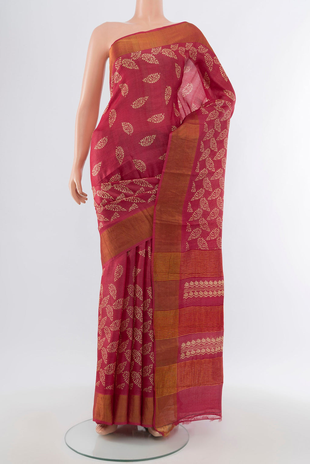 Peach Tussar Silk Saree with Floral Print on the body and Silk Border.  displayed on a mannequin