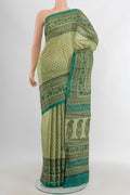 Beige Tussar Silk Saree with Printed design on the body and Printed Border.  displayed on a mannequin