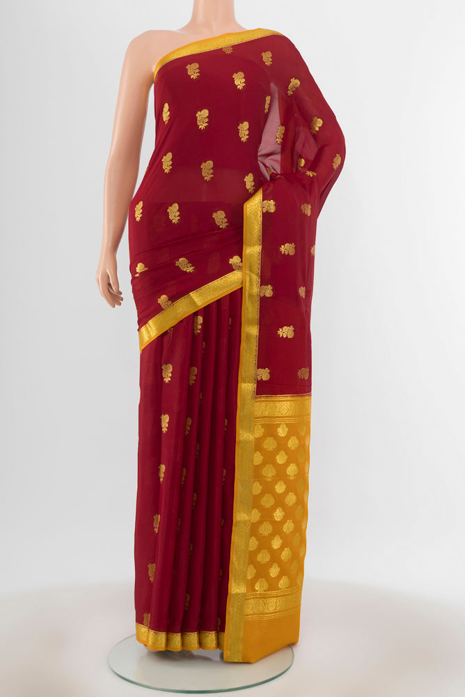 Maroon Mysore Crepe Saree with Zari Butta on the body and Zari Border.  displayed on a mannequin