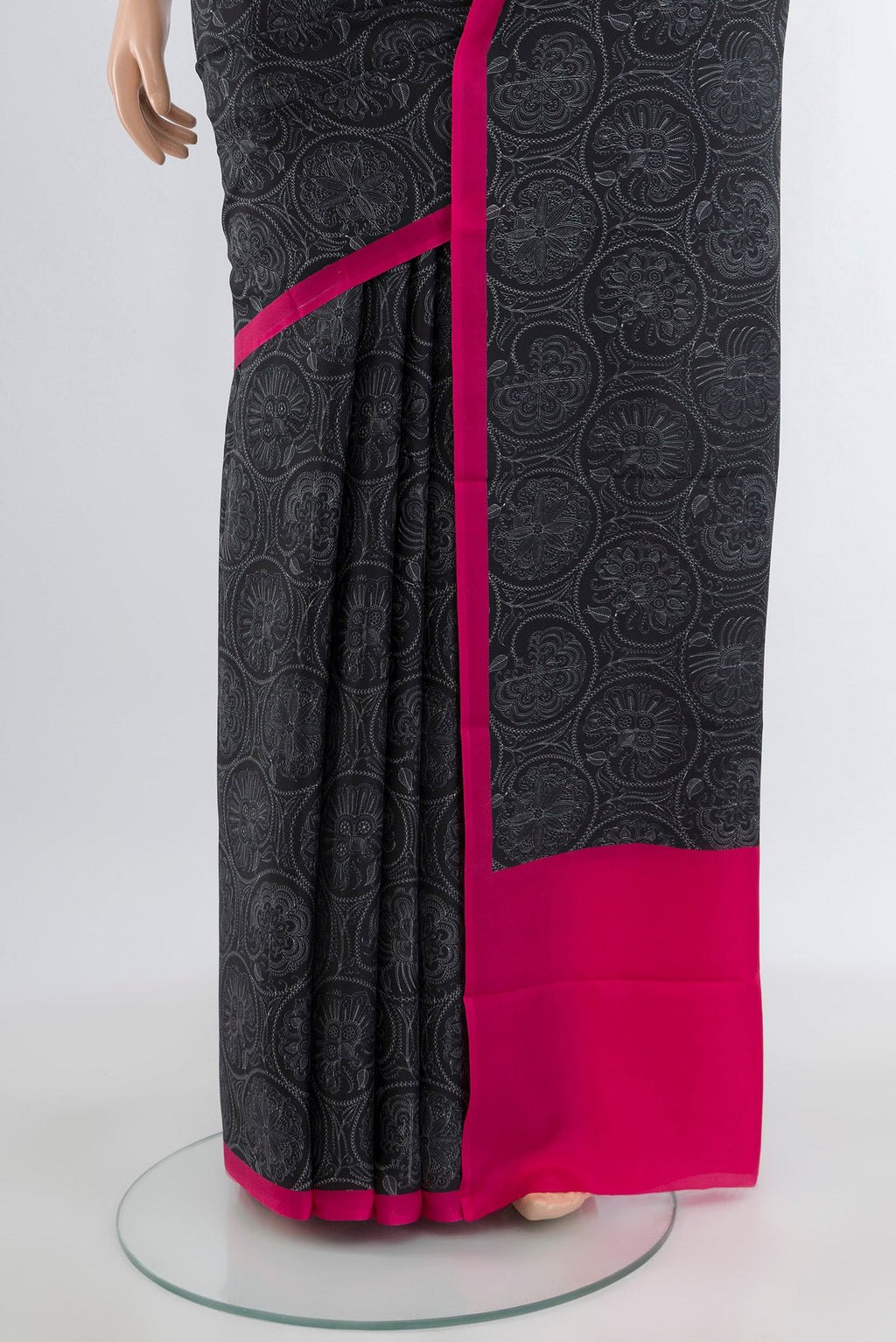 Pleats and pallu of Black Printed Silk Saree with Floral Print on the body and Plain Border. 