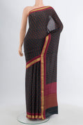 Black Crepe Saree with Floral Print on the body and Zari Border.  displayed on a mannequin