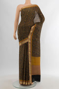 Black Crepe Saree with Floral Print on the body and Zari Border.  displayed on a mannequin