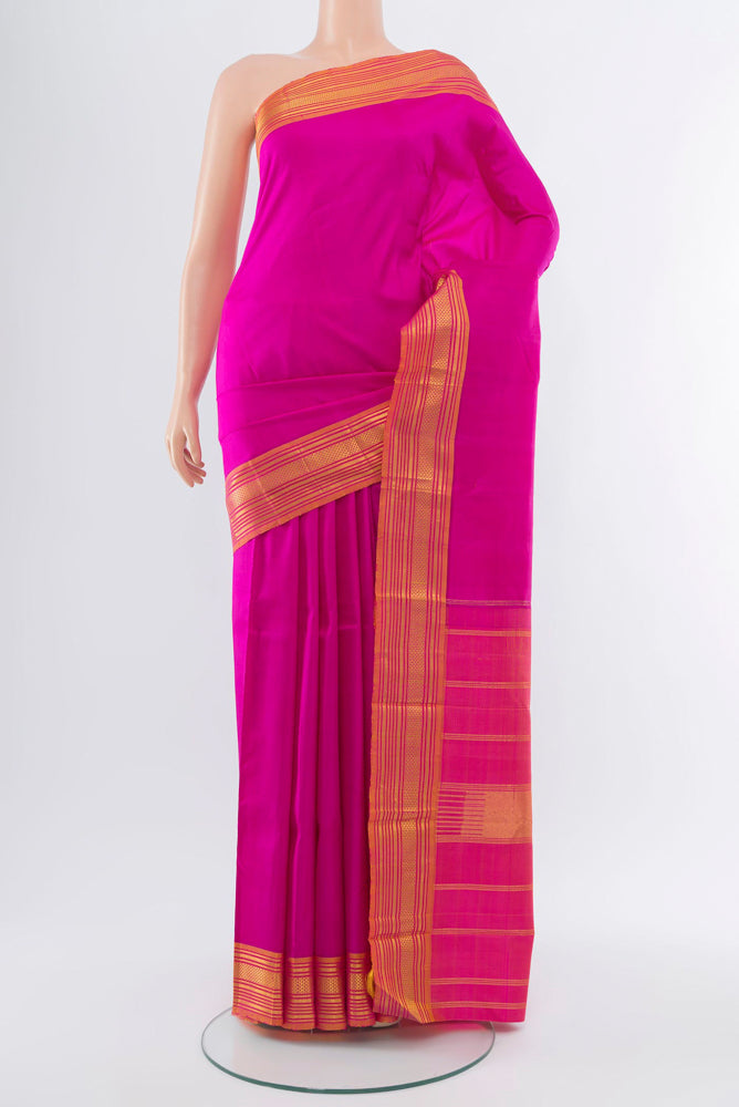 Rani Pink Kanchipuram Silk Saree with Zari Butta on the body and Silk Border.  displayed on a mannequin