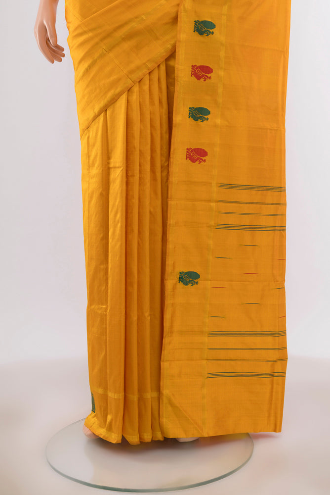 Pleats and pallu of Yellow Kanchipuram Silk Saree with Plain Body and Zari Border. 
