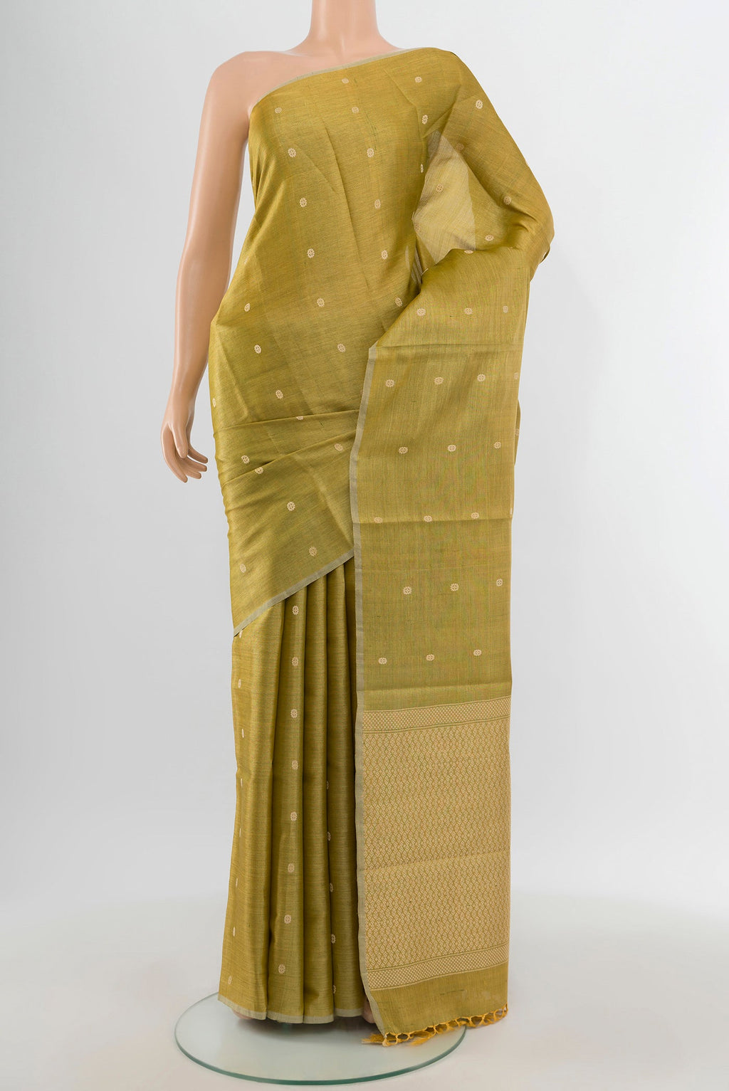 Golden Tussar Silk Saree with Zari Butta on the body and Zari Border.  displayed on a mannequin
