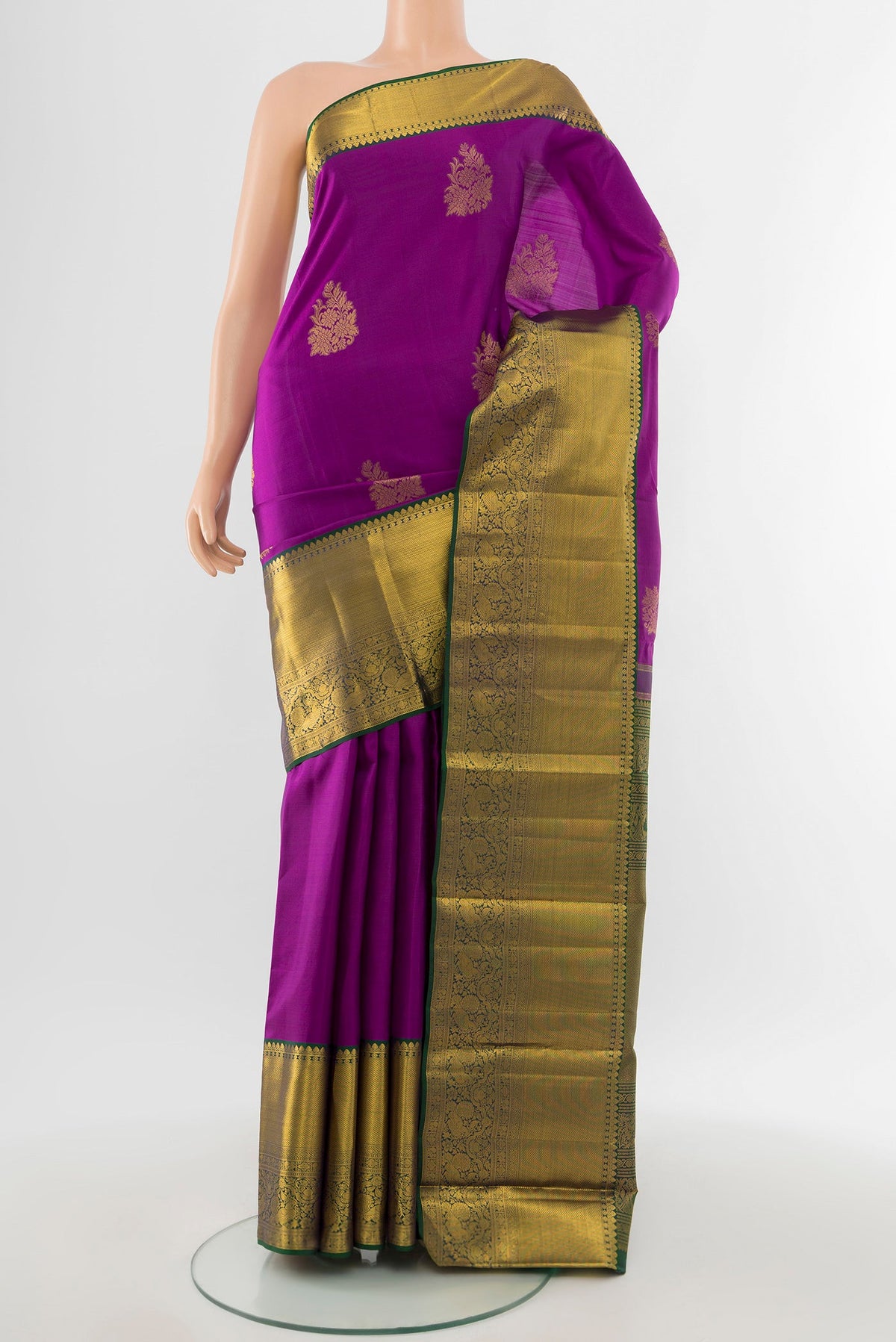 Pure Silk Pure Zari Magenta Kanchipuram Saree with Zari Butta on the body and Silk Border.  displayed on a mannequin